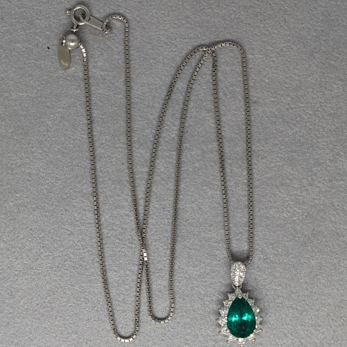 Pear Shaped Emerald and Diamond Halo Pendant Necklace in Platinum