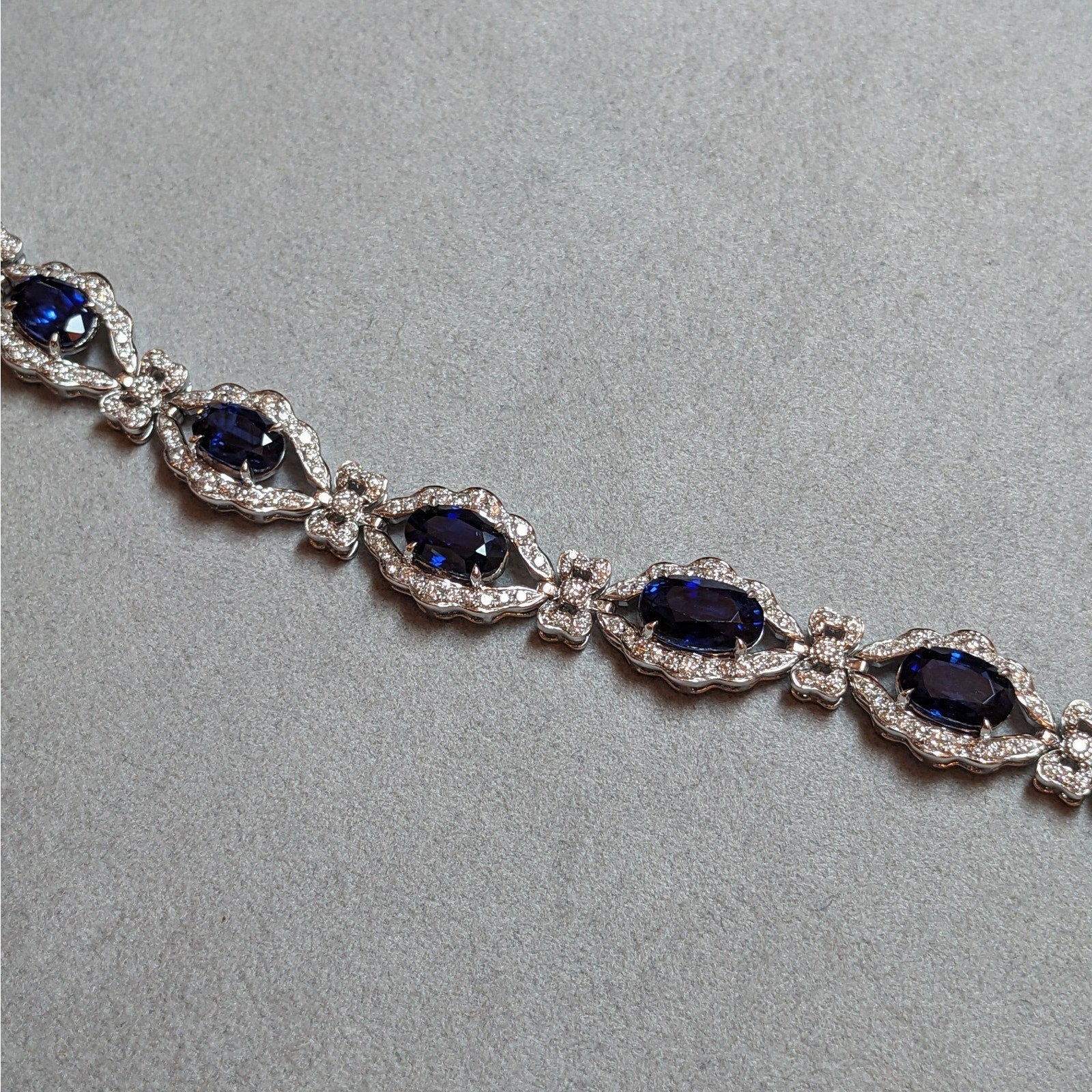 Blue Sapphire and Diamond Station Bracelet with Bows in Platinum