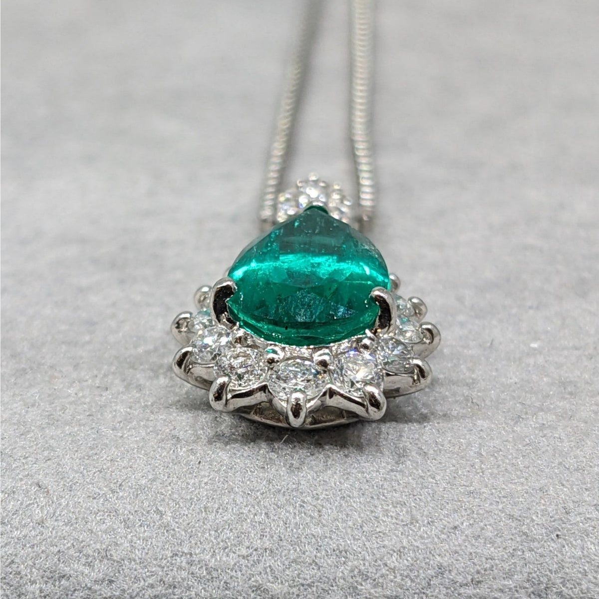 Pear Shaped Emerald and Diamond Halo Pendant Necklace in Platinum