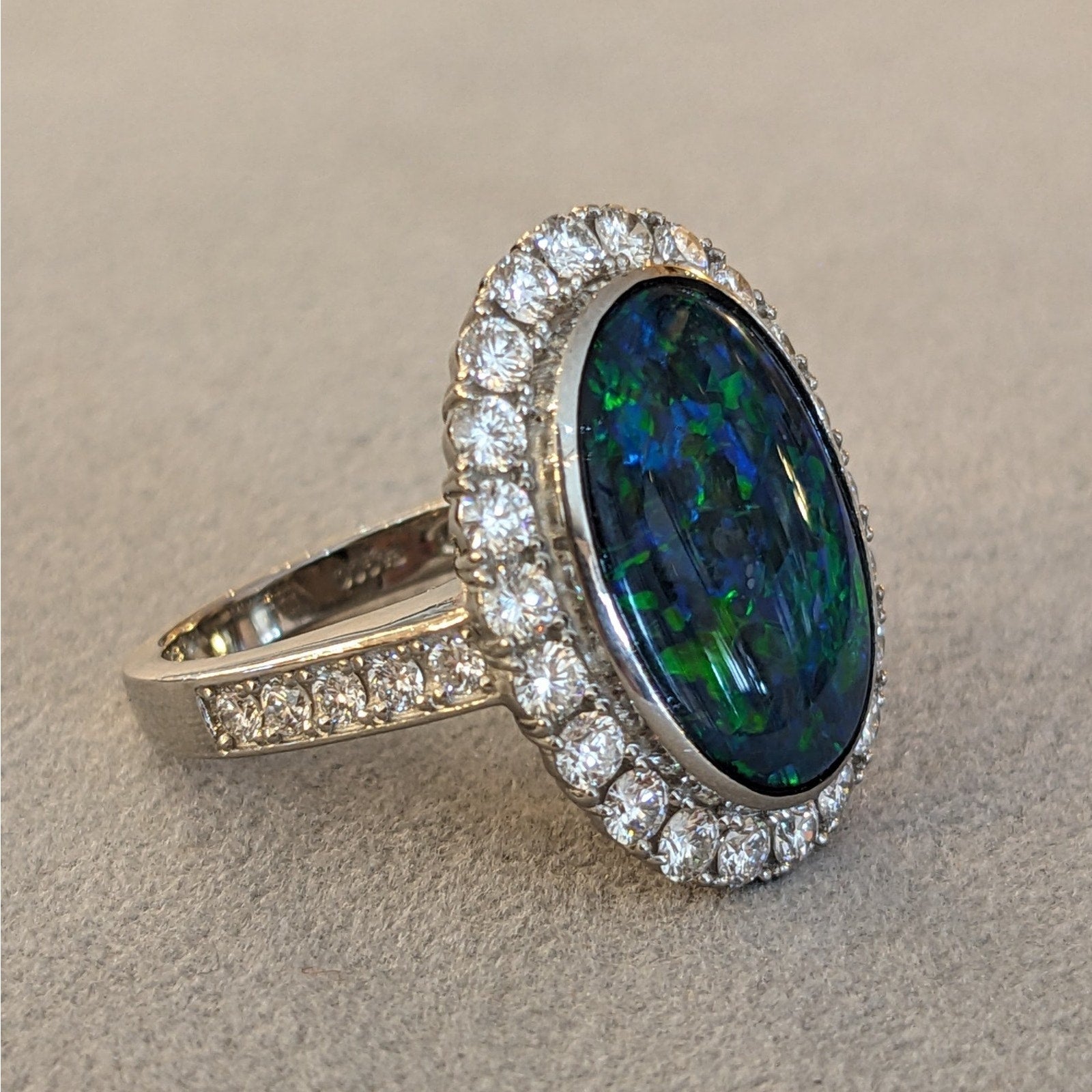 6.31 cts. Natural Black Opal and Diamond Halo Ring in Platinum